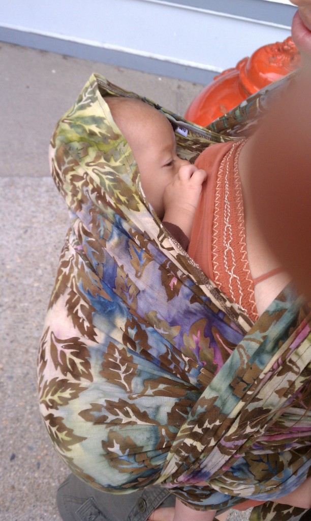 Nursing in a FWCC cradle carry with gauze Kimber wrap