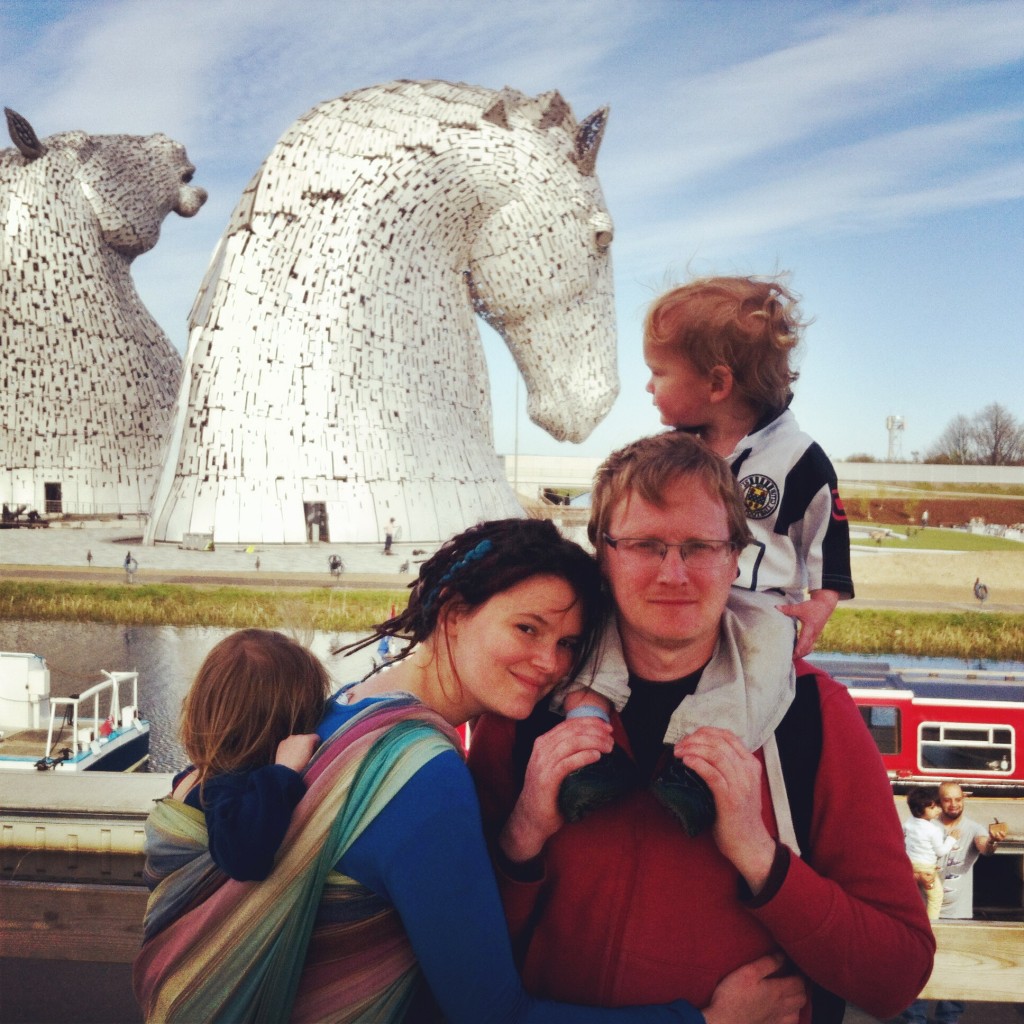 Babywearing in front of the Kelpies in Falkirk in Scotland.