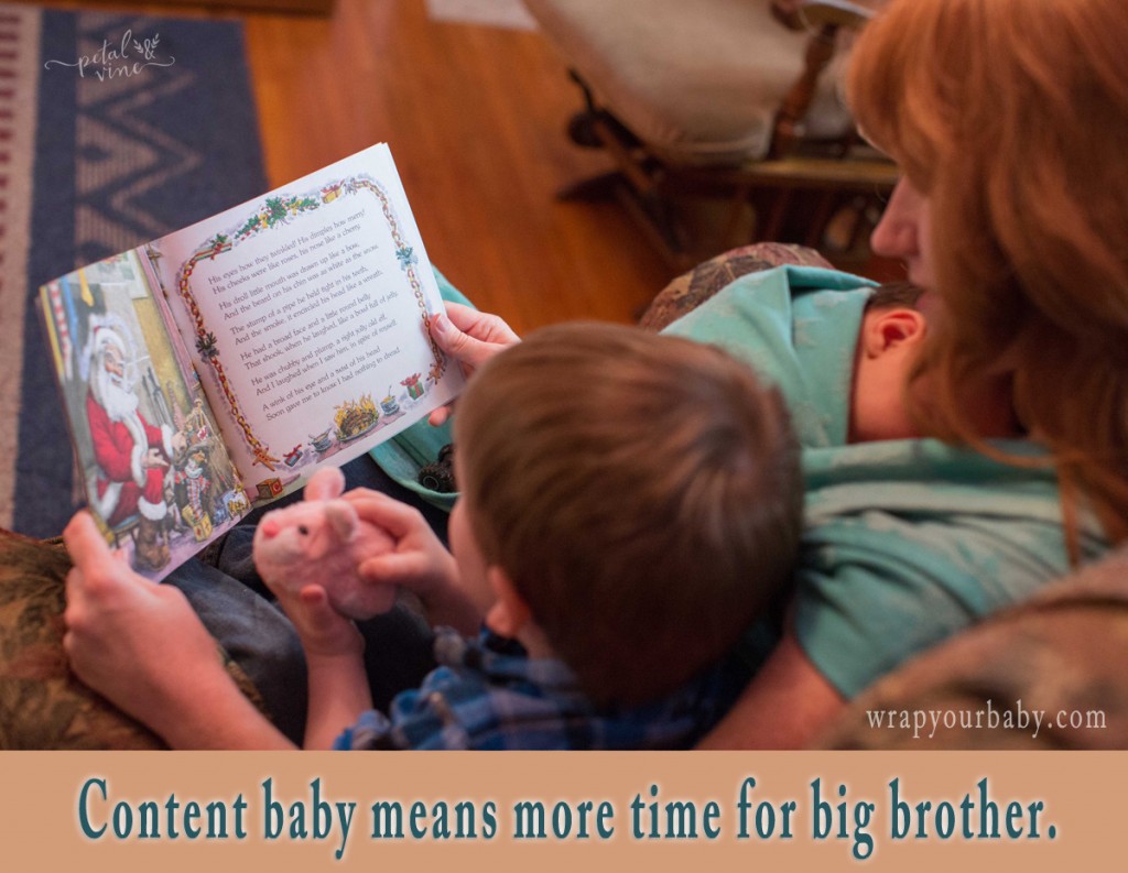 Spending time with big brother while baby is wrapped.